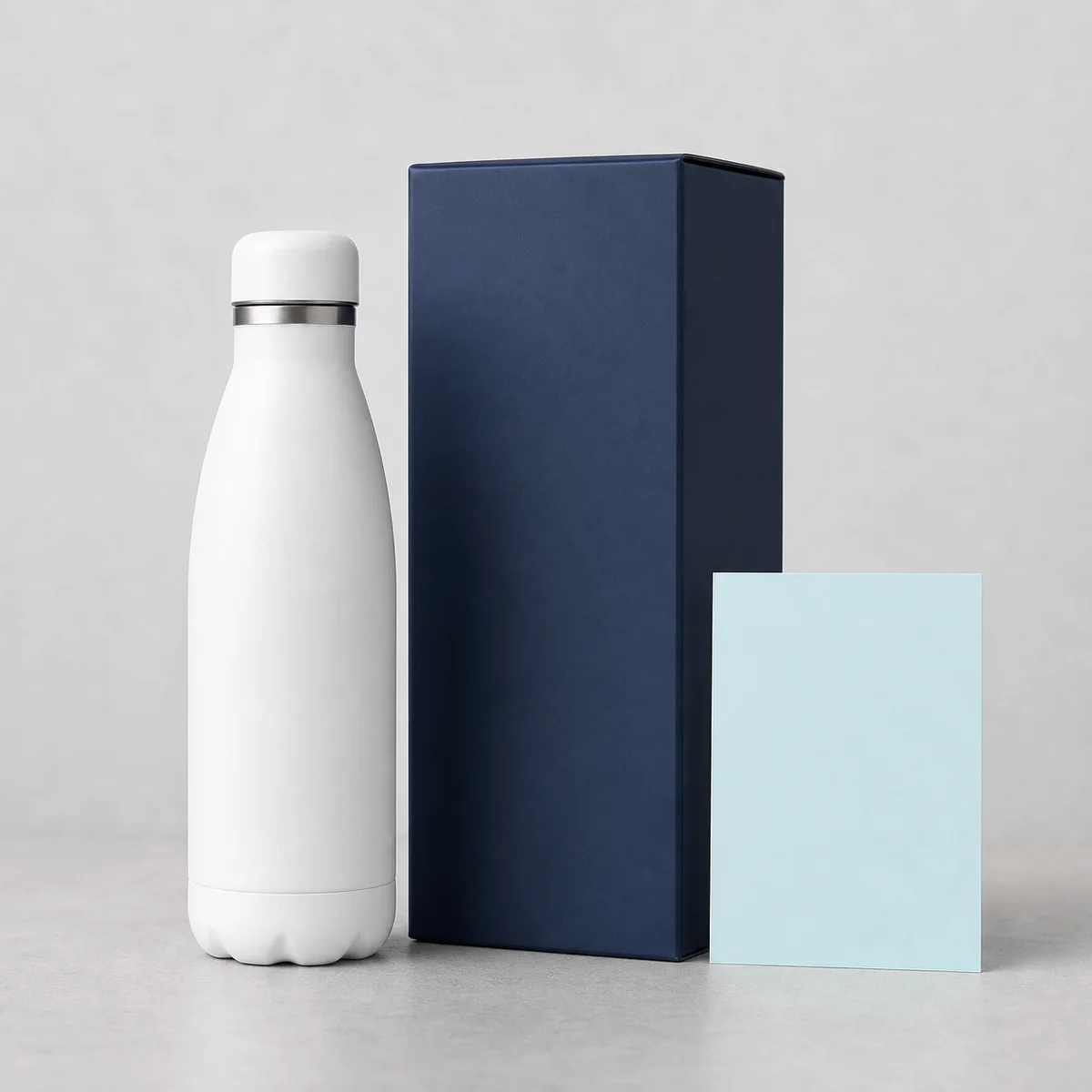 White bottle with blank navy packaging and insert card